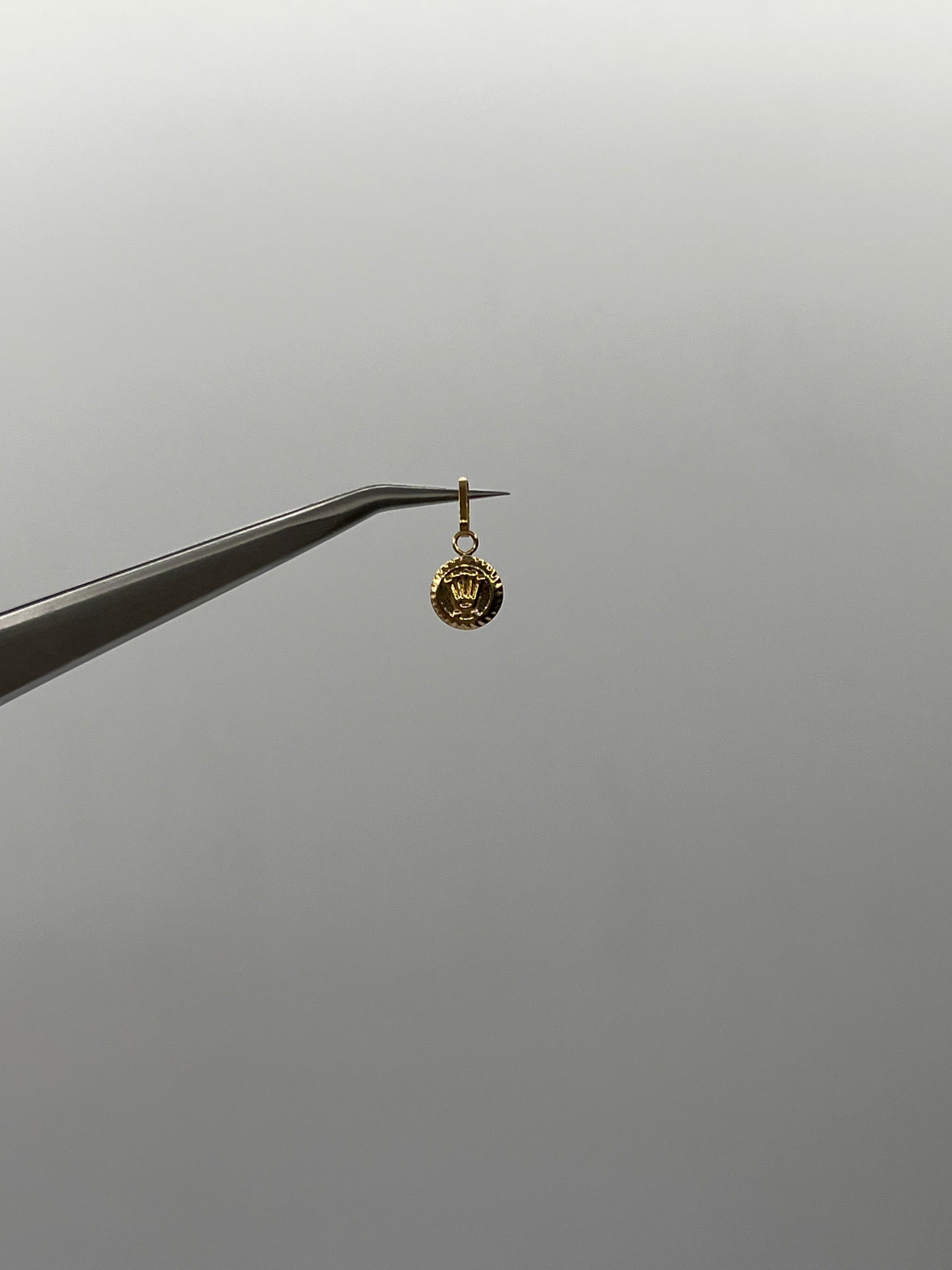 Dije RX Oro amarillo 18k 0,25 Gr / 7 mm / 0,9 Cm