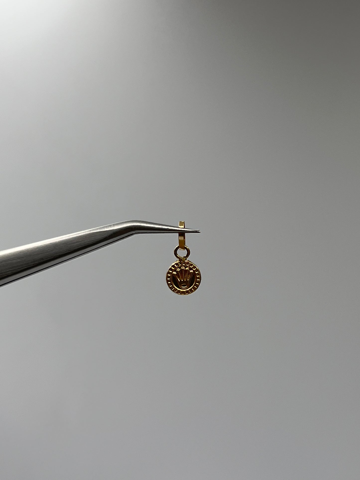 Dije RX Oro amarillo 18k 0,29 Gr / 7 mm / 0,7 Cm